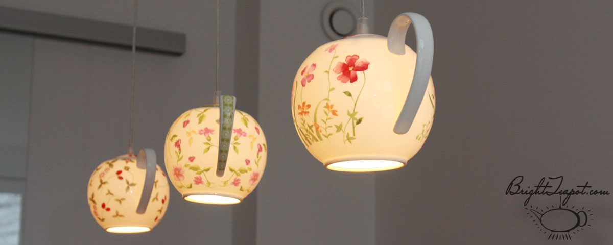 Three glowing teapot lamps